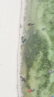 Vertical Video Boats in the Ocean Near the Coast of Zanzibar Tanzania