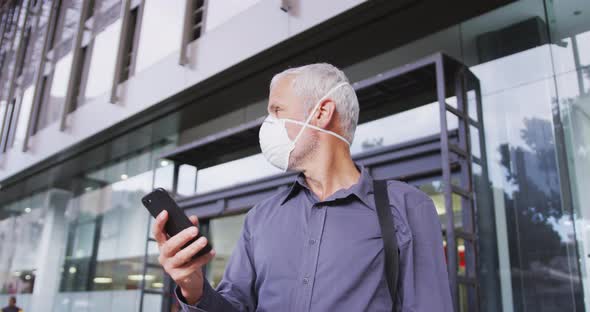 Caucasian man out and about in the street wearing on a face mask against coronavirus