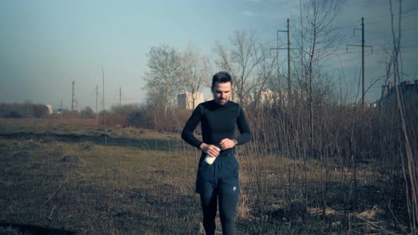 Tired Runner Drinking Water. Triathlete Drinking Isotonic In Running Pause. Runner Relaxing.