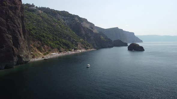 Aerial View From Above on Calm Azure Sea and Volcanic Rocky Shores