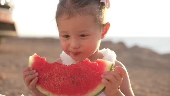 Closeup Portrait of Charming Pretty Baby Girl Enjoying Taste of Healthful Watermelon on Family