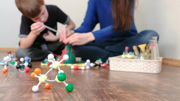 Blur Background. Mom and Son Are Doing a Volcano Experiment