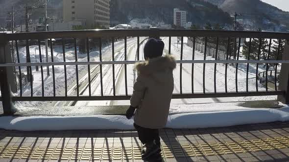 Asian Child Running On The Bridge In Winter Day Slow Motion