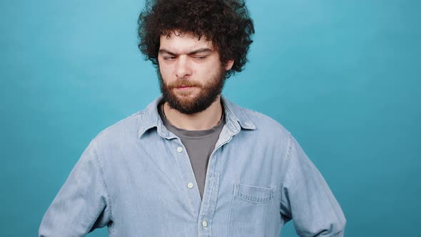 Young Man Puts Index Finger to Lips Showing Silent Gesture