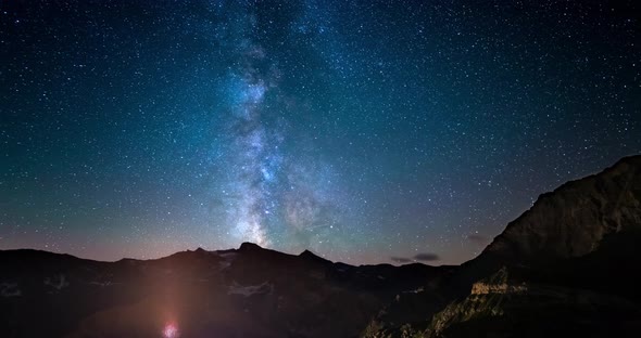 Time Lapse of the Milky way and the stars in summer night sky rotating over the Alps