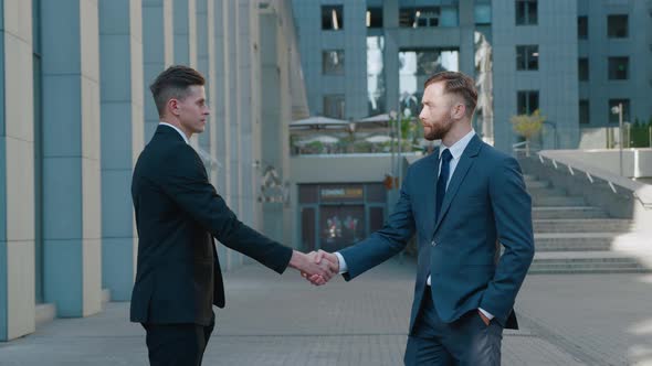 Two Business Men Shake Hands When Meeting, Agree To a Deal or Say Hello. Portrait of Handshake of