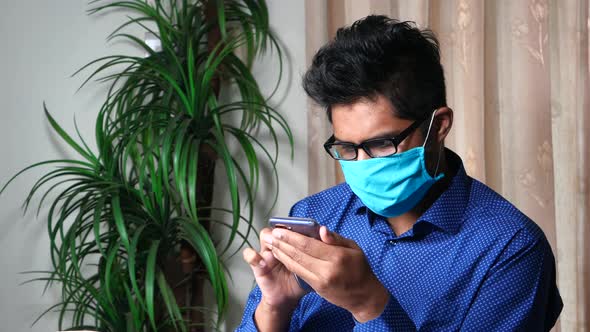 Man Freelancer in Medical Face Mask Talking Mobile Phone,