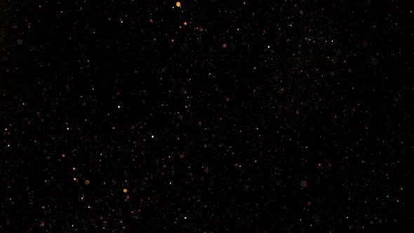 Super Slow Motion Shot of Golden Glitter Background Isolated on Black at 1000 Fps