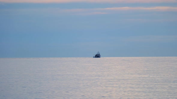 Sea Horizon With Cargo Ship Silhouette - wide