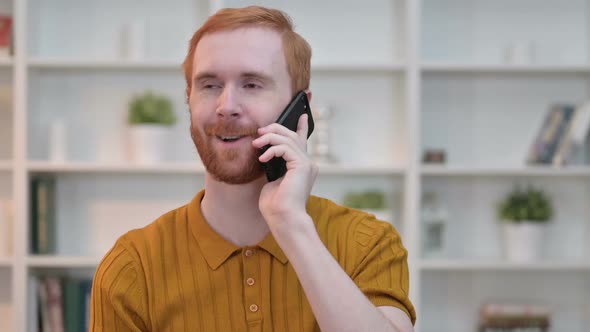 Portrait of Cheerful Redhead Man Talking on Smartphone