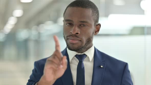 Portrait of African Businessman Saying No with Finger Sign 