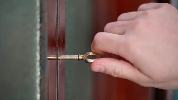 Opening an Old Sideboard with a Golden Key Closeup