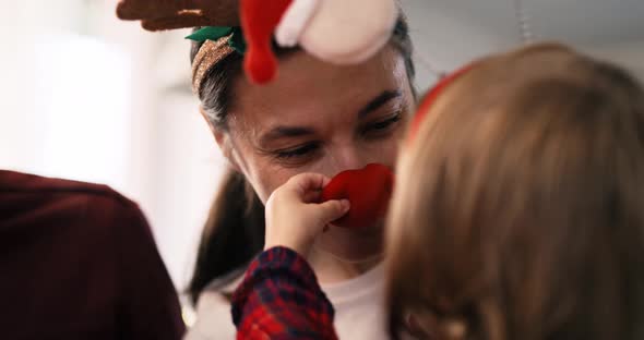 Handheld view of playful family in Christmas time