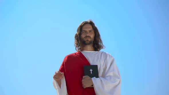 Preacher in Robe Showing Hand of Benediction, Holding Bible, Blessing Christians