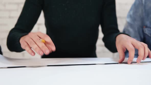 Multiethnic Group of People Working Together Drawing a Plan Using Pencil and Ruler