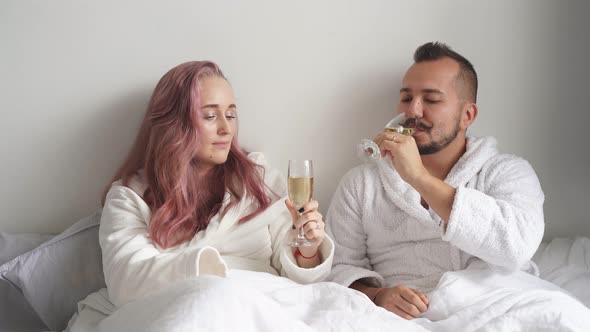 Caucasian Man and Woman Drinking Sparkling Wine