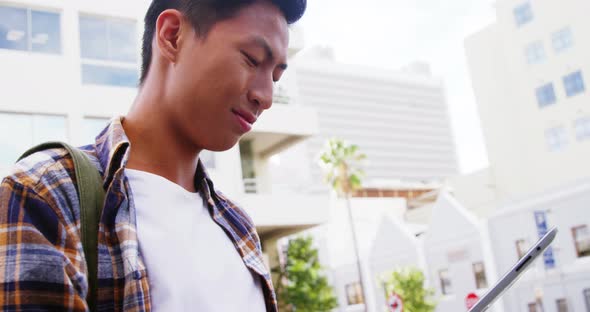 A man walking and using a tablet computer