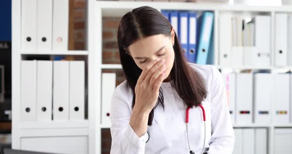 Tired Female Doctor in Stress Clinic Workplace