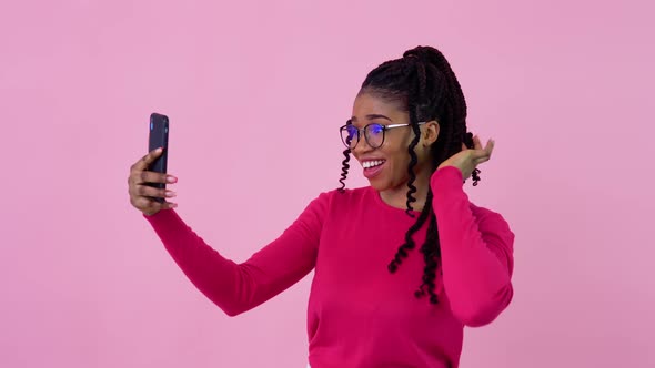 Cute Young African American Girl in Pink Clothes Communicates By Video Link