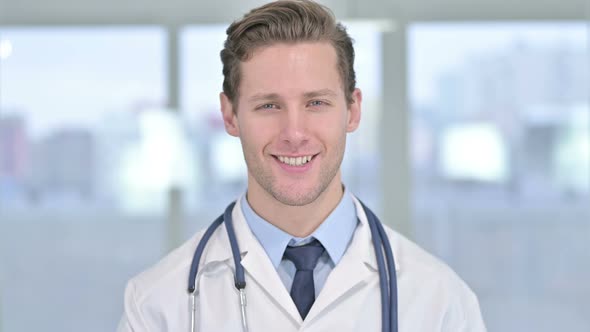 Portrait of Smiling Young Male Doctor Looking at the Camera 