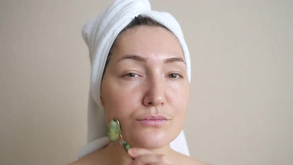 Closeup of Woman Doing Facial Massage with Jade Roller