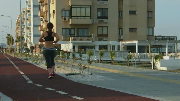 Young Motivated Woman Jogging to Have Healthy Fit Body. Outdoor Sport Activity