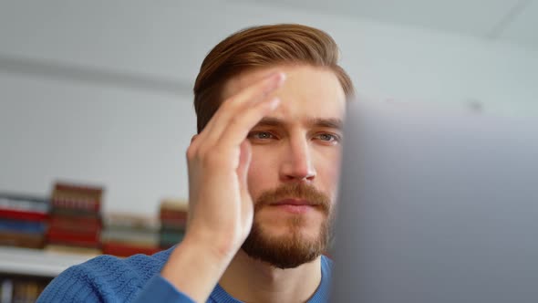 Sad businessman working on a laptop