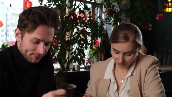 Young People Have Lunch in a Restaurant