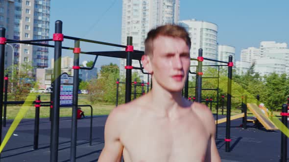 A Young Man Does a Street Workout