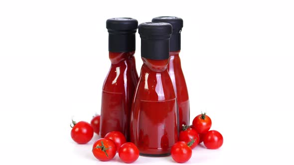 Close-up, Nicely Arranged Several Small Bottles of Tomato Sauce, Food Products Rotate on White