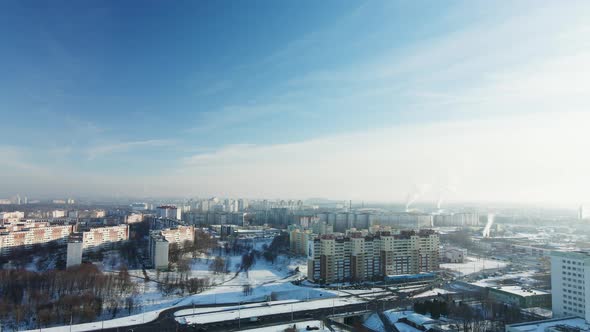 Flight over the city block. Winter cityscape. There is a railway line nearby.