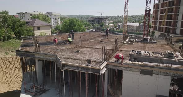 Topdown Aerial View on the Roof of an Office Skyscraper in a Building Under Construction with Many