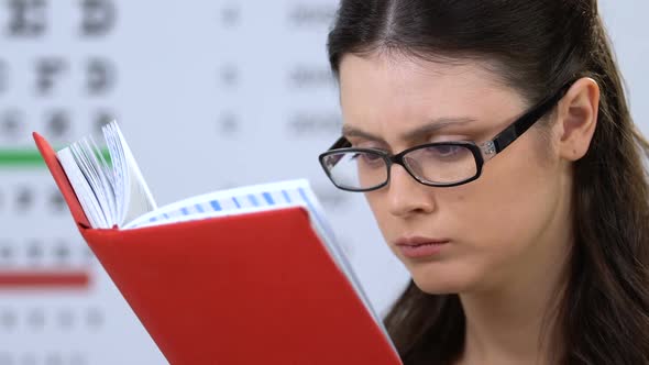 Concentrated Female Student in Eyeglasses Reading Book, University Education