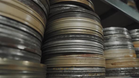 A pile of оld round metal boxes with film strip in them