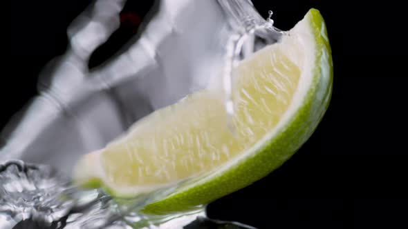 Water splash on cut lime. Slow Motion.