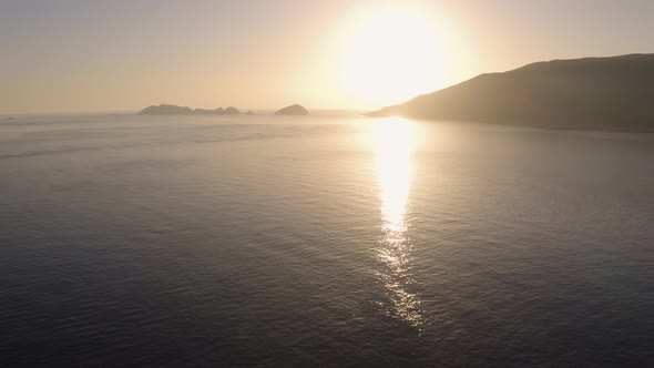 Aerial View of Sunset Over the Sea and Mountains