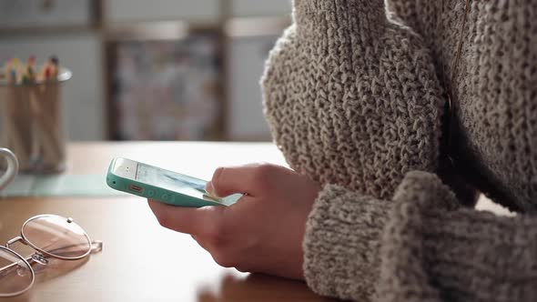 Young Woman Scrolling her Smartphone