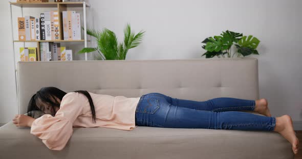 woman laying down sofa to sleep