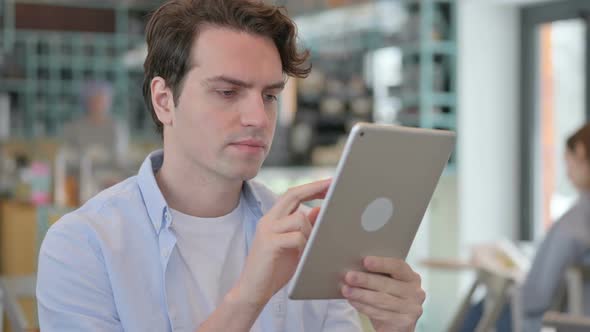 Portrait of Creative Man Celebrating Success on Tablet