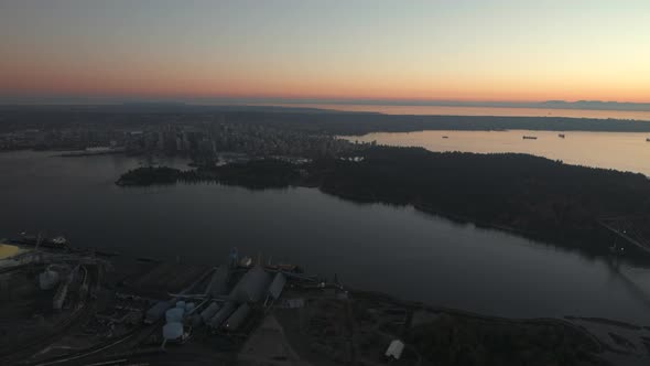 Aerial wide shot of Downtown Vancouver and Stanley park from North Shore, Dusk