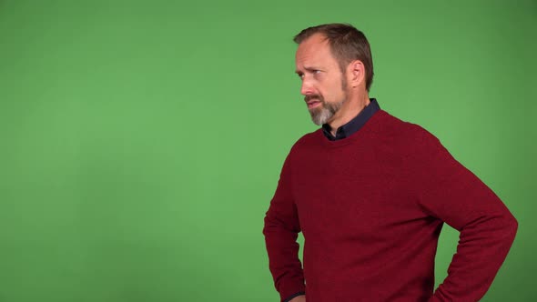 A Middleaged Handsome Caucasian Man is Angry and Sulks  Green Screen Background