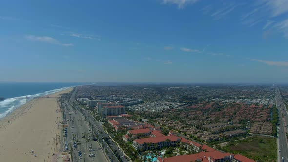 Flying over Huntington Beach with a view of the pier in the distance.