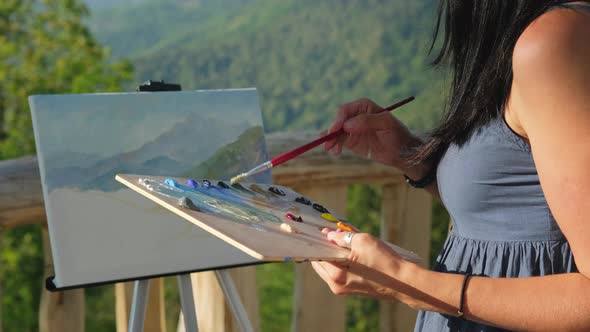 Unknown Female Artist Is Drawing Mountainscape Outdoors