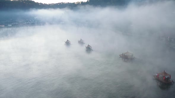 Aerial View of Sunrise with Fog Over Ban Rak Thai Chinese Village Near a Lake in Mae Hong Son