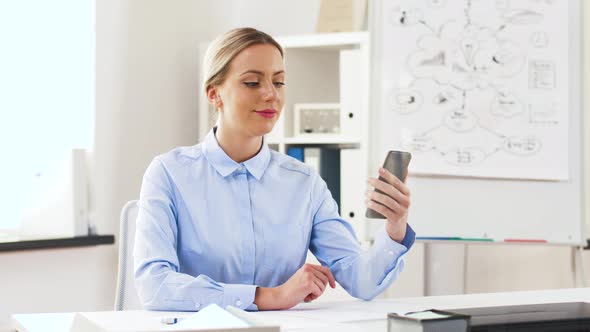 Businesswoman Having Video Call on Cell at Office 37