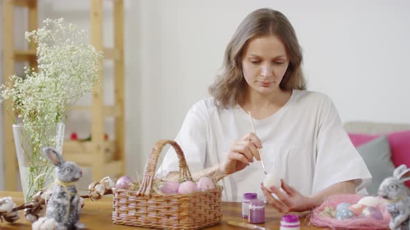 Young Woman Painting on Easter Egg