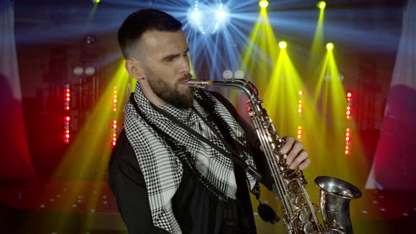 Live Performance of Saxophonist Man with Saxophone Dancing on Concert Musician Stage with Lights