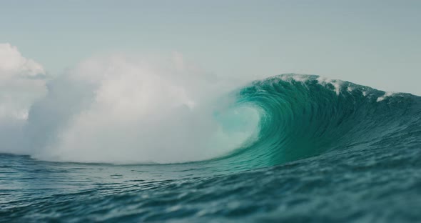 Ocean wave breaking and barreling with spray