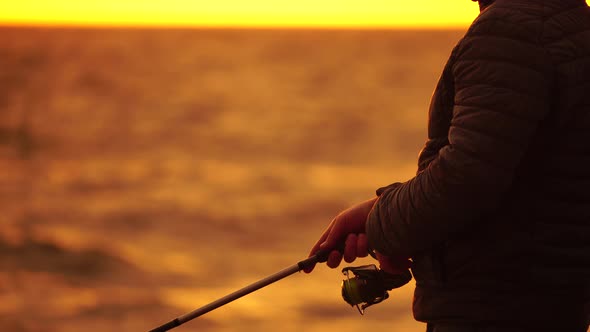 Man Hobby Fishing on Sea Tightens a Fishing Line Reel of Fish Summer