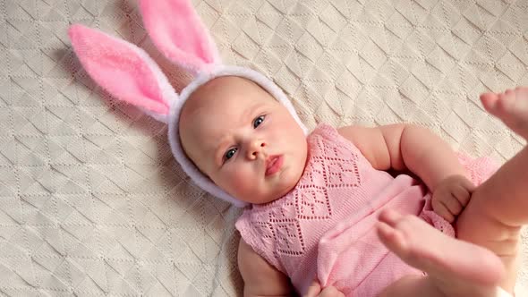 Funny Little Child is Wearing Bunny Ears Smiling and Looking to the Camera